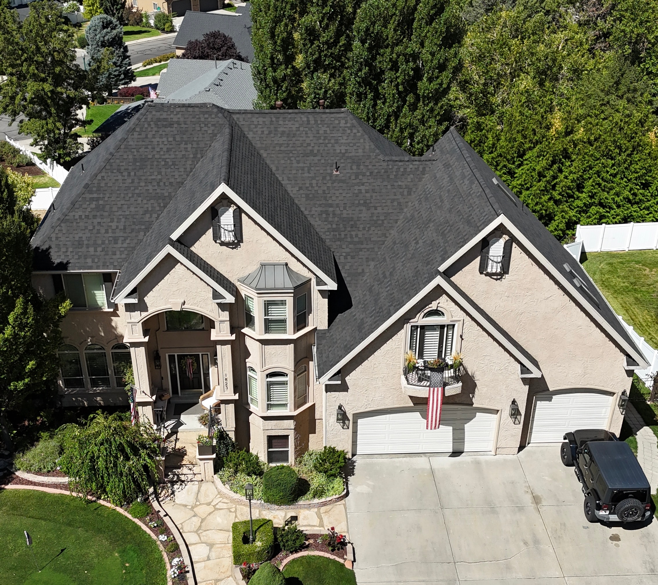 Charcoal shingle roof replacement on stucco home in Utah County